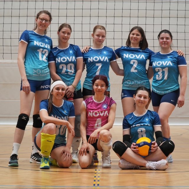 NOVA women's volleyball team together at the net